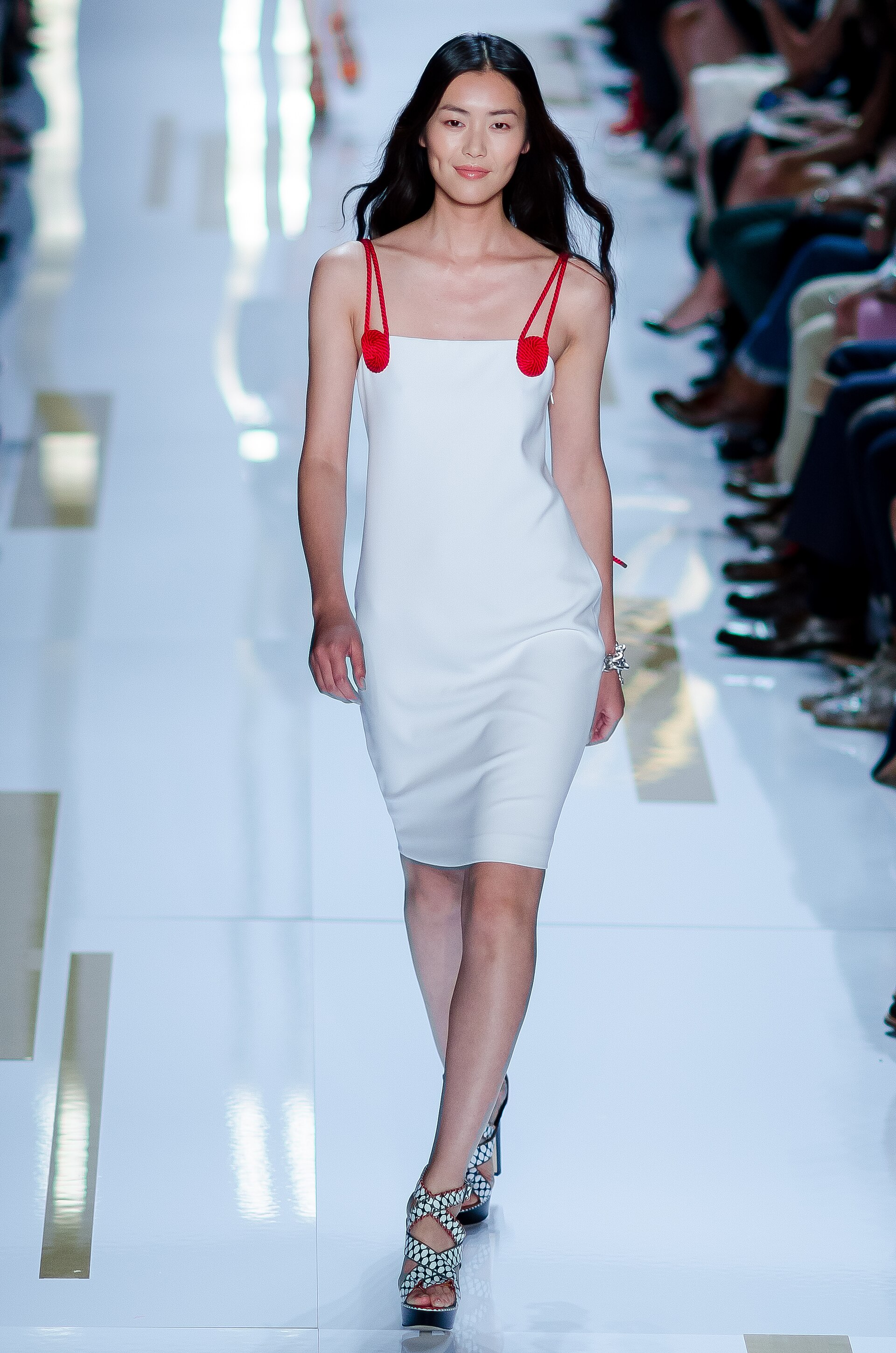 A model walks a runway in a composed look from a spring collection.