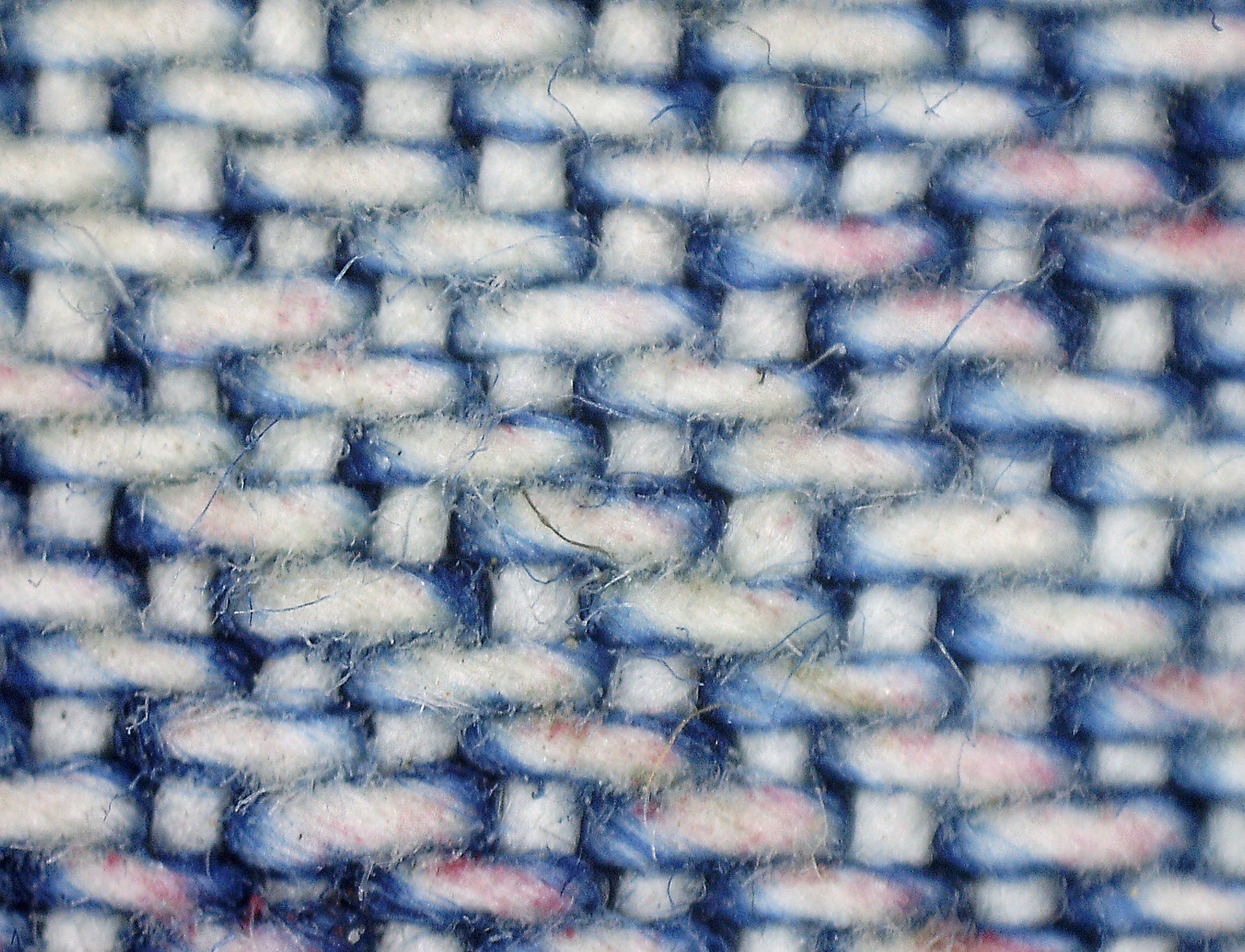 A pair of blue jeans showing the fading and whiskering that come from wear and washing.